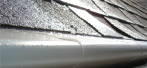 Example of gutter with leaf guard protection covering it in weatherby