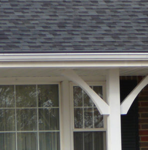 Close up of charcoal gutter cover and roof with white gutter