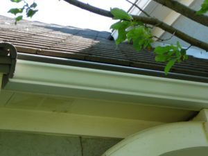 Tile roof with Bronze gutter cover installed