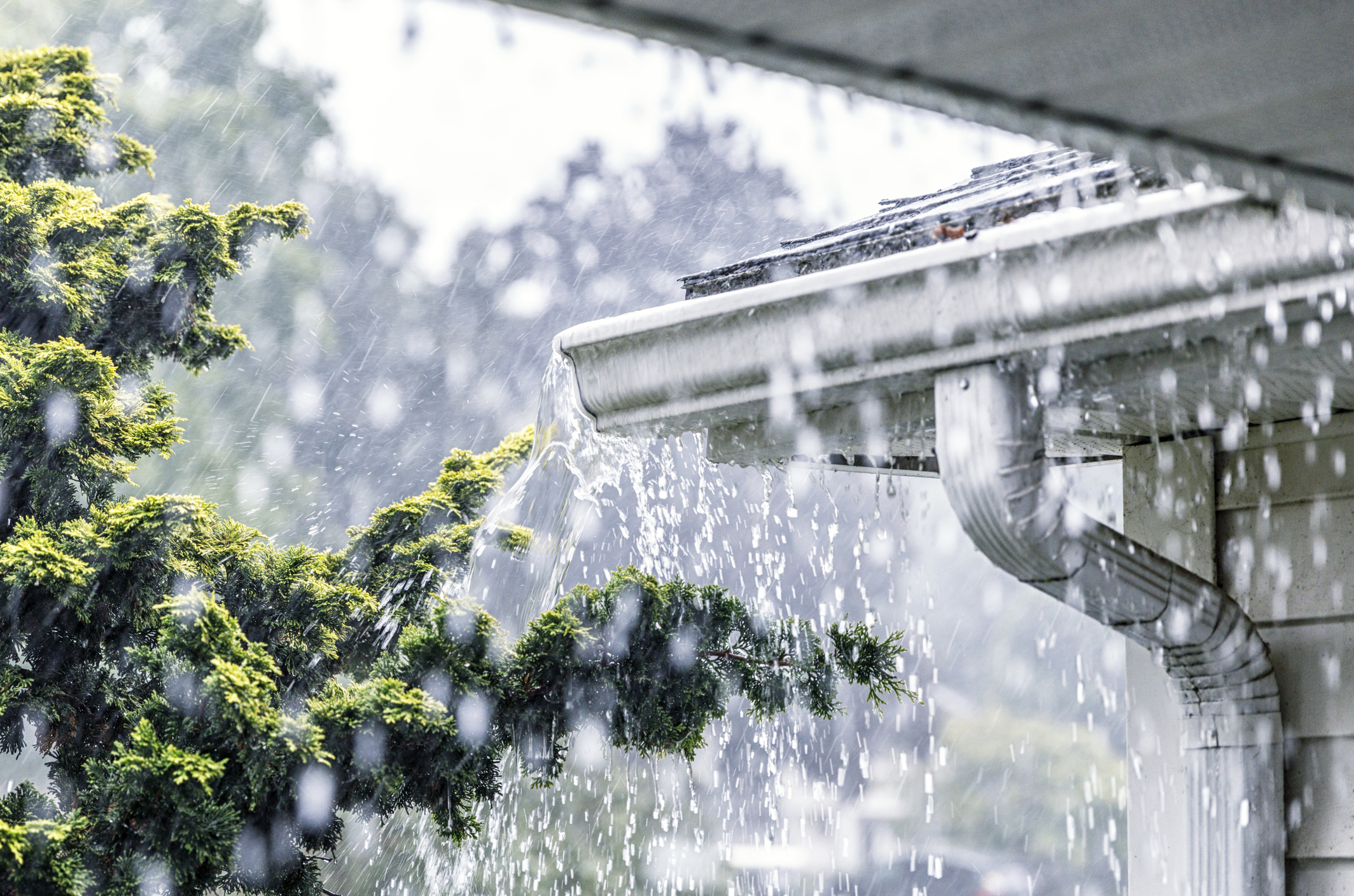 rain pouring over a guttering system