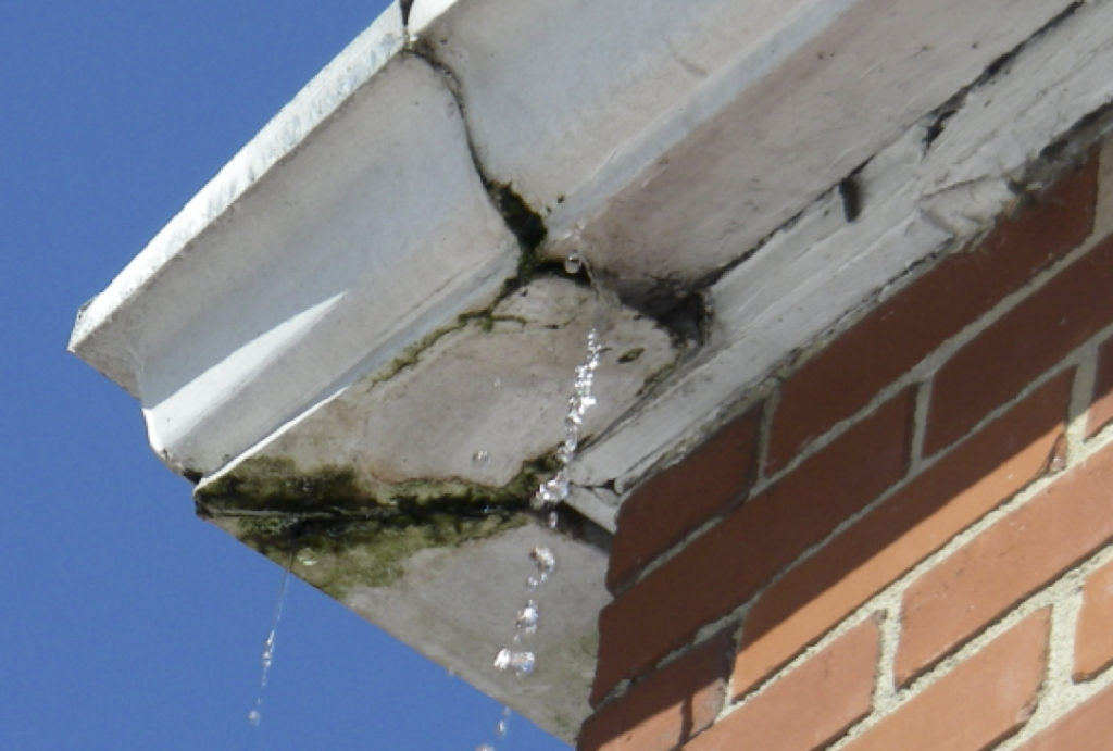 Corroded aluminum gutter allowing water to leak through