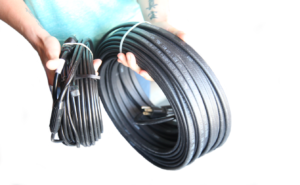 man-holding-two-types-of-heat-cables-one-self-regulating-the-other-constant-wattage
