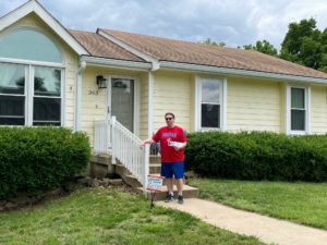 fox-4-gutter-give-away-winner-standing-in-front-of-his-home-with-new-gutters-and-advantage-gutter-guard-installed
